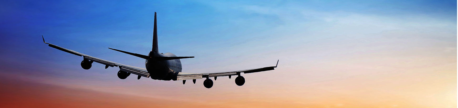 Plane flying in sunset